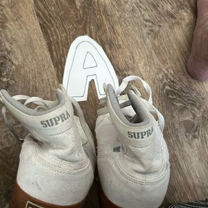 Supra size 12. White with gold souls, gently used.